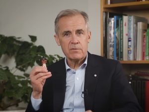 Prime Minister Mark Carney holds a tiny figurine of Maj.-Gen. Sir Isaac Brock.