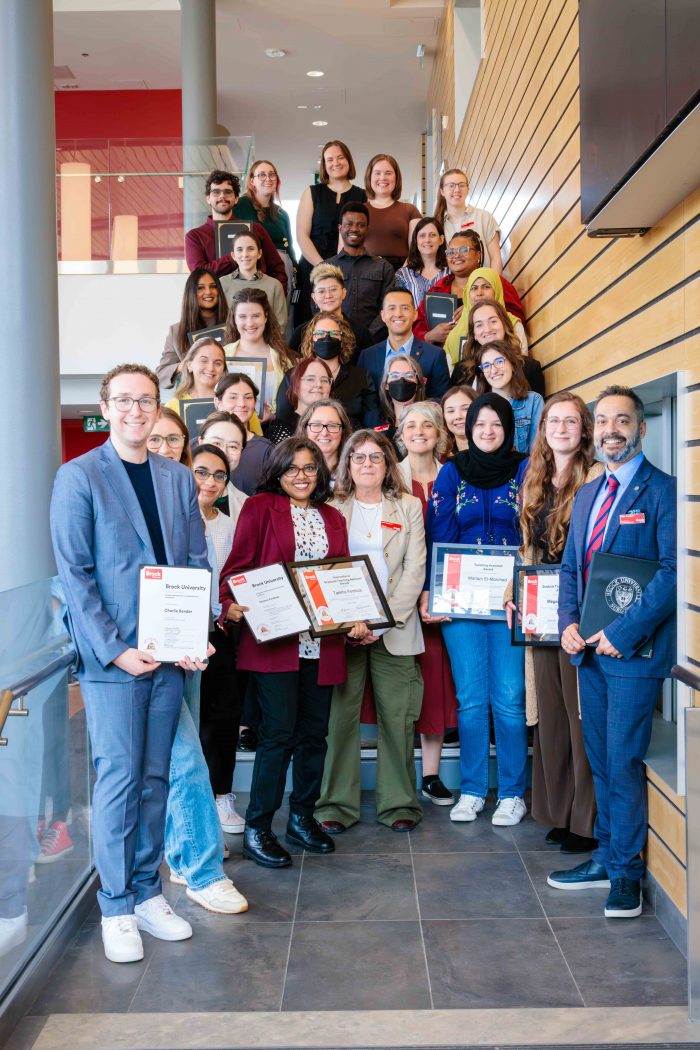Honorees from the annual CPI teaching assistant celebration on a staircase.