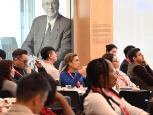 An audience listens to someone speak at an event.