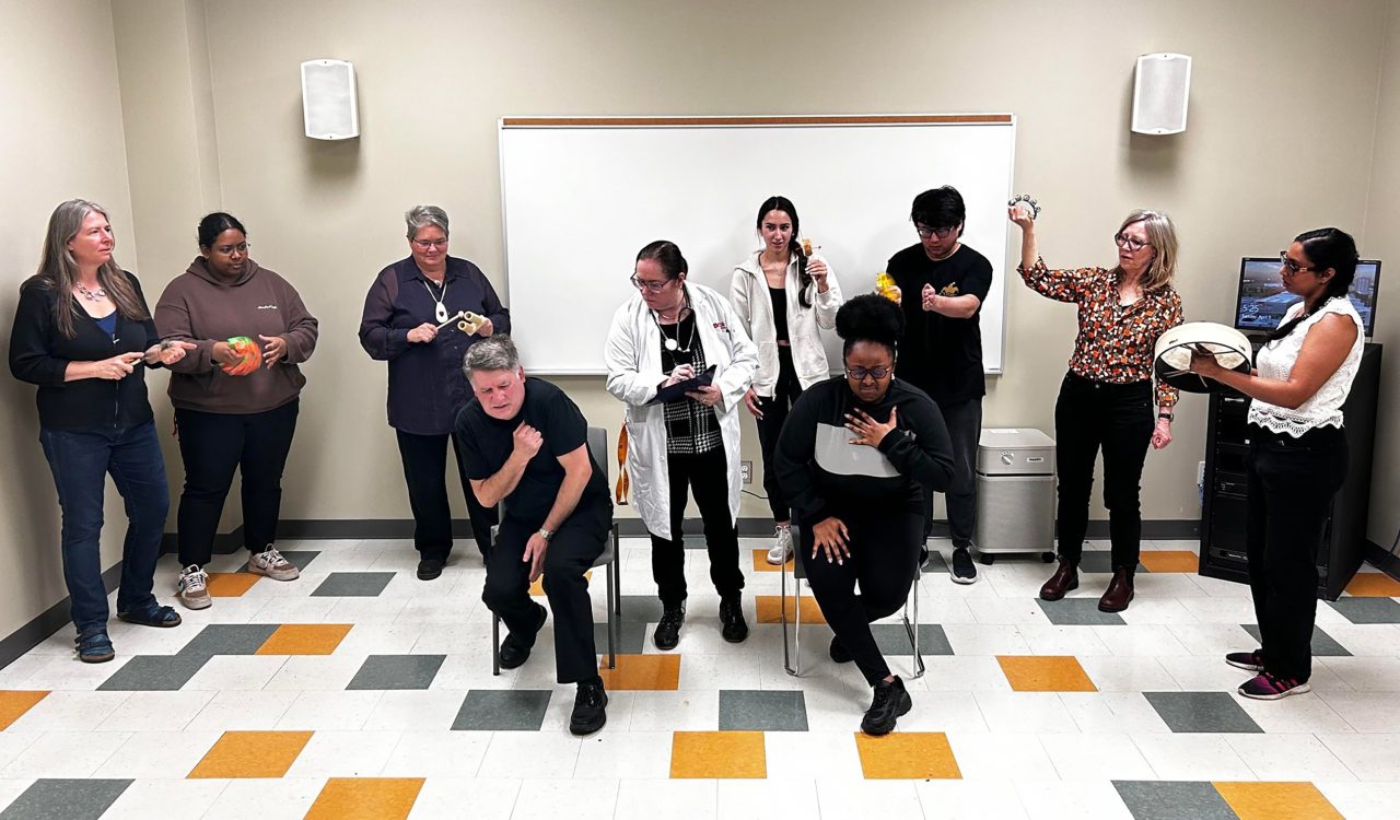 A group of people act out a health-care scenario in a play.