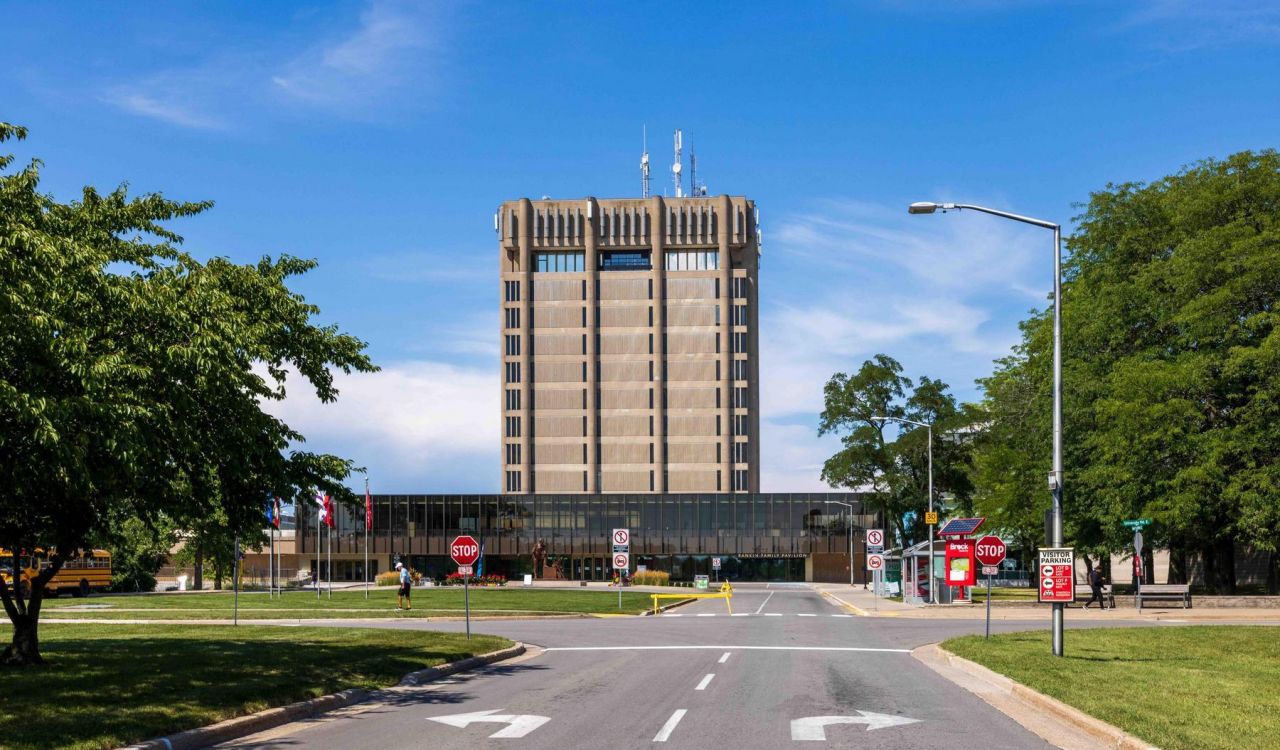 A concrete tower against a blue sky with a road leading up to it.