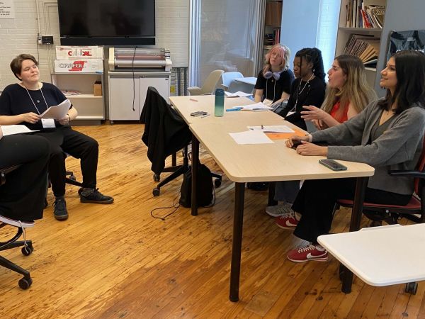 A group of students rehearse a play in a university classroom.
