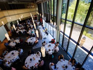 Seen from above, an aerial view shows a group of people at a wine tasting.
