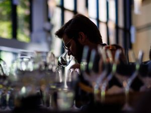 A man smells a glass of wine.