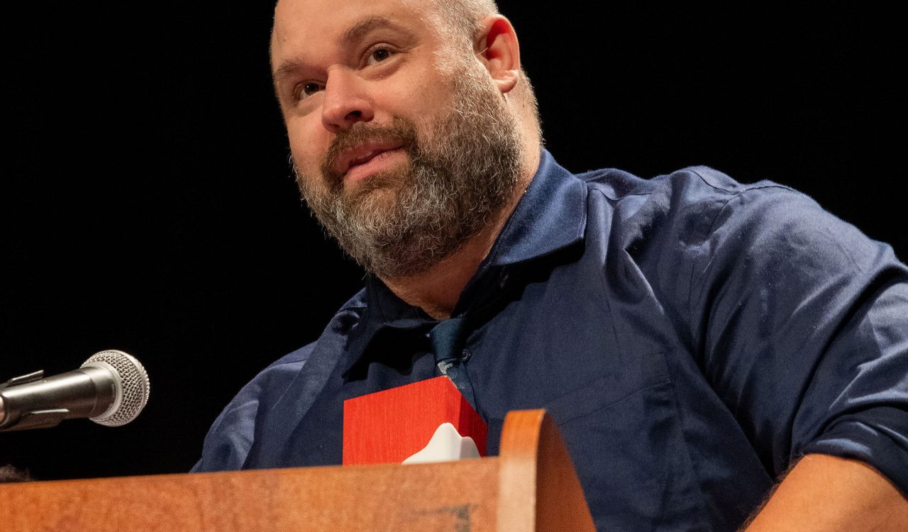 A man stands at a podium making a speech.