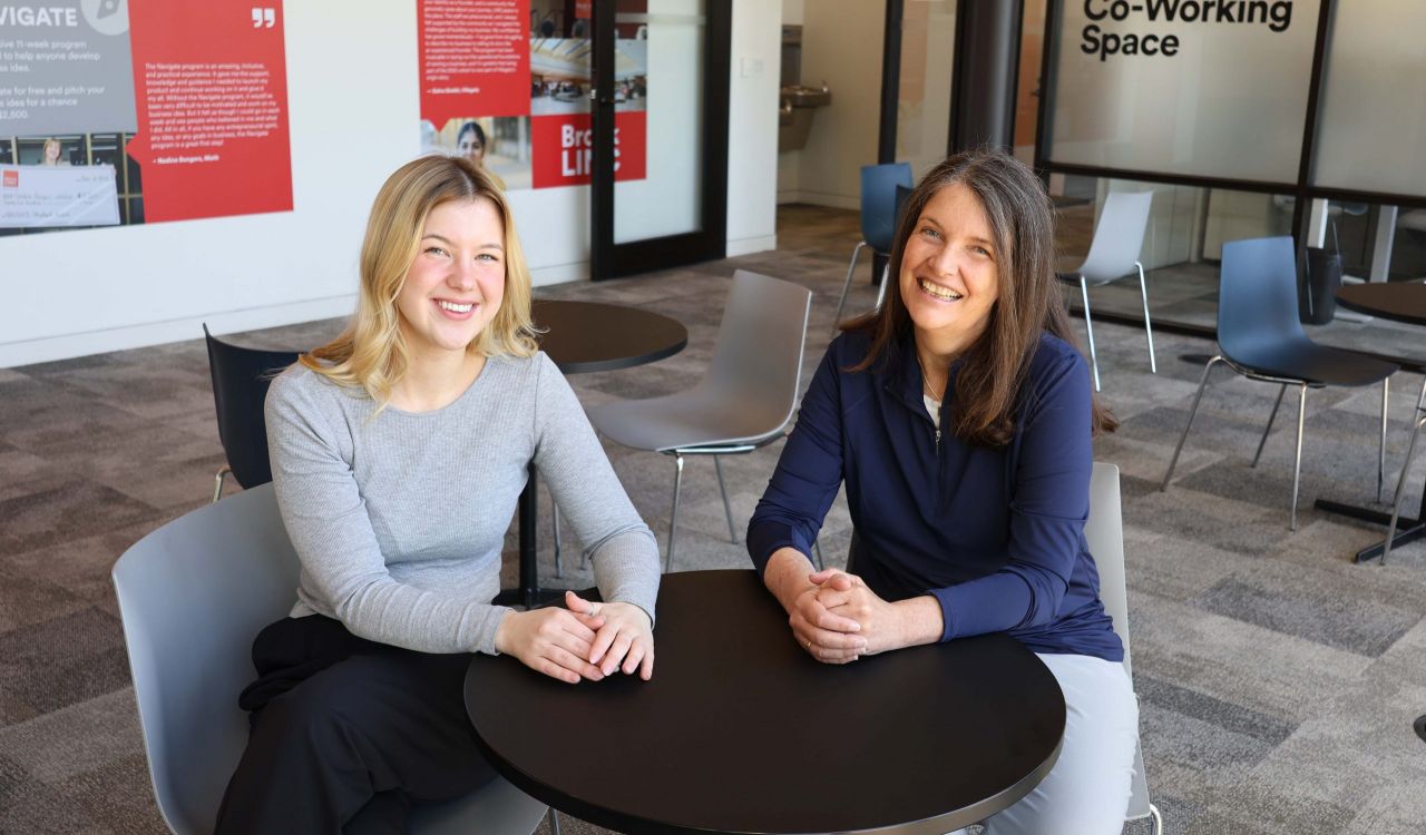 Nadine Bongers and Kate Cassidy seated at a table in the Brock LINC.
