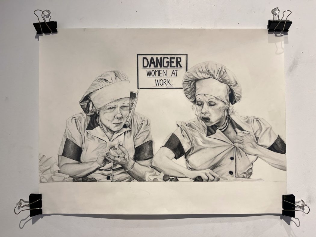 A pencil drawing shows a rendering of two TV characters working at a chocolate factory. 