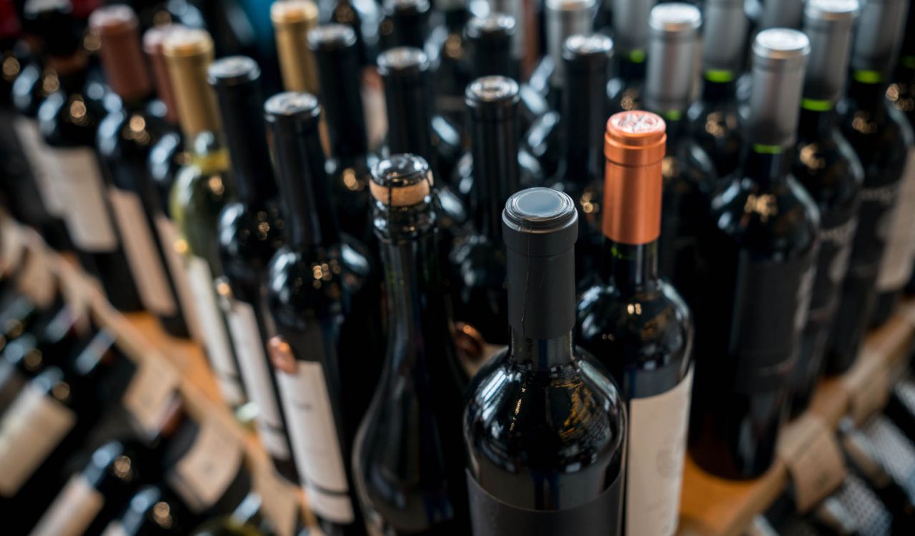 Rows of wine bottles on a store shelf.