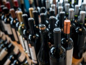 Rows of wine bottles on a store shelf.