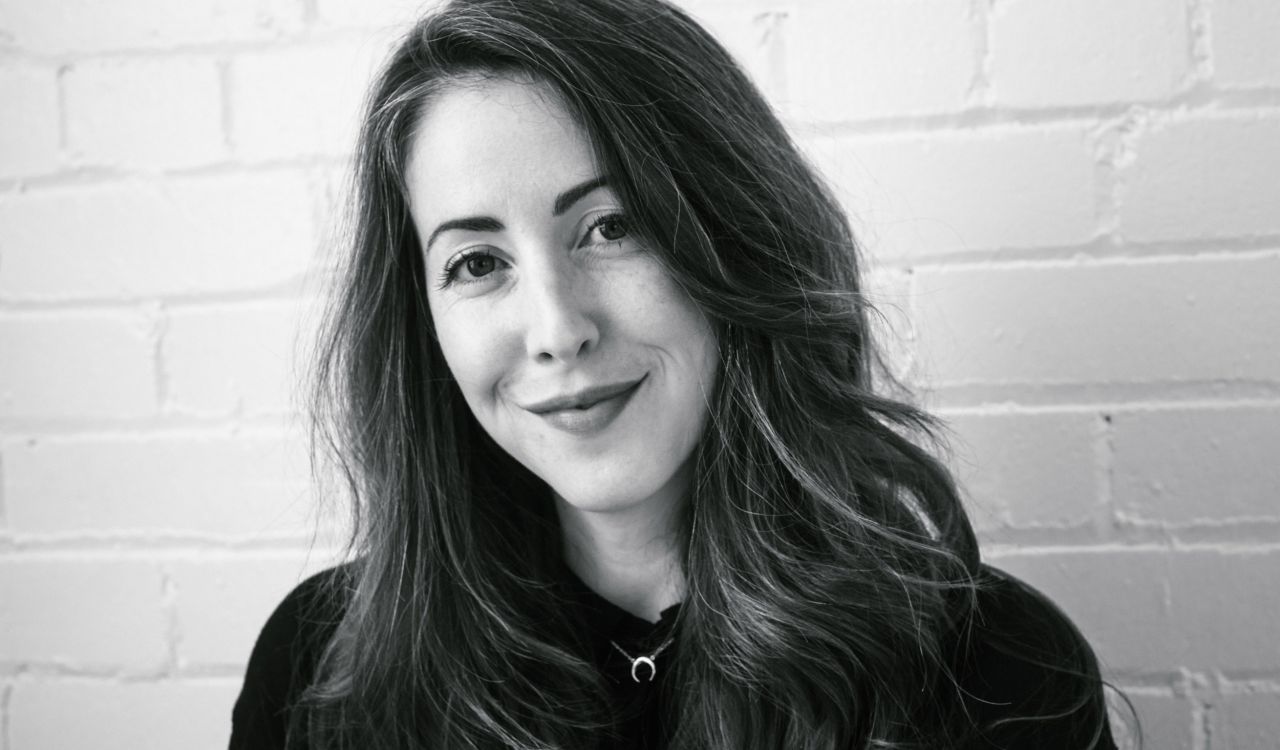 A woman smiles at the camera.
