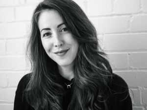 A woman smiles at the camera.