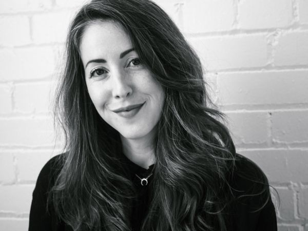 A woman smiles at the camera.
