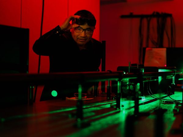 Jianbo Gao works with lasers in a Brock University research lab.