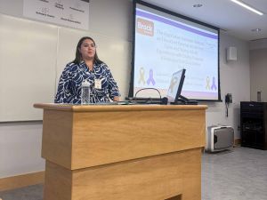 Julia Collin Pereira presenting at a conference session.