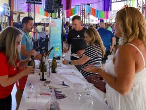 Two CCOVI experts stand behind a table pouring wine for event for International Cool Climate Chardonnay Celebration (i4C) event attendees.