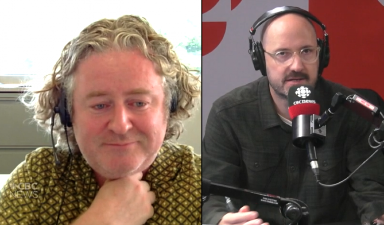 On the left side of a split screen, a man is seated in an office wearing headphones and appears to be listening intently. On the right side, a man is seated in a studio, wearing large headphones, speaking into a CBC News microphone.