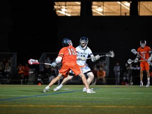 Men play in a lacrosse game.