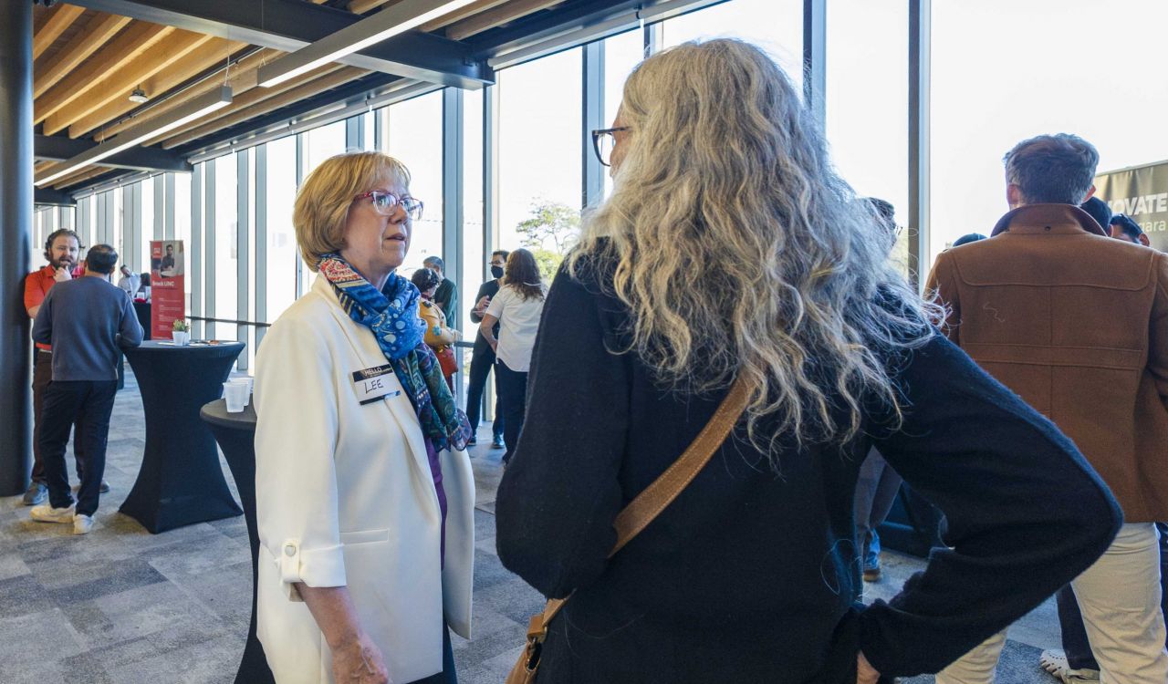 People speak to each other a networking event.