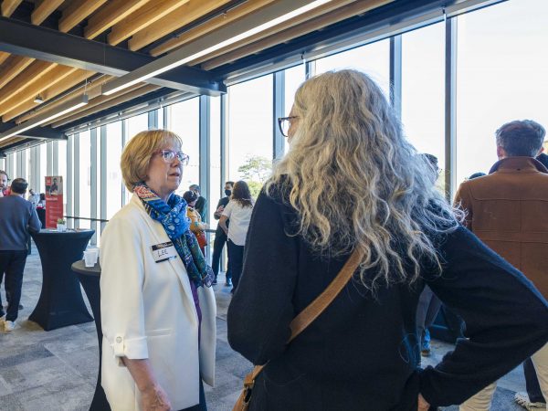 People speak to each other a networking event.