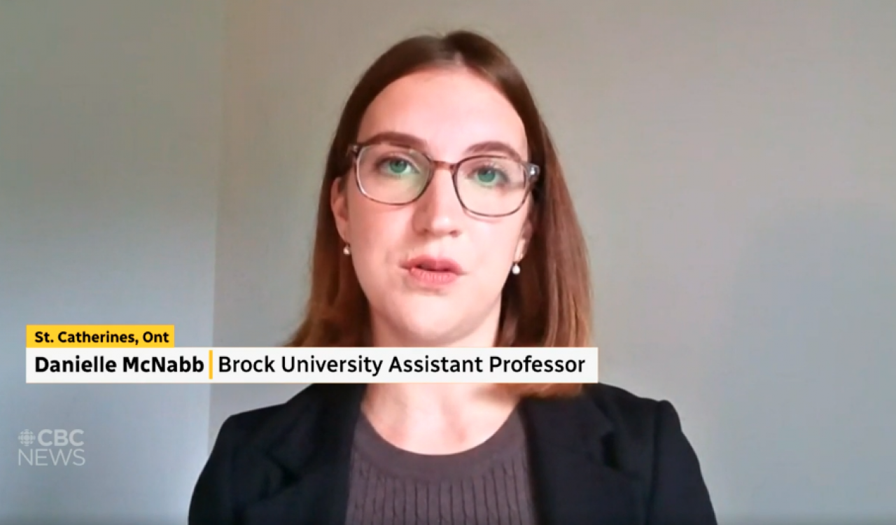 Screenshot of a CBC News television newscast featuring an interview with a female guest wearing glasses participating remotely via Zoom.