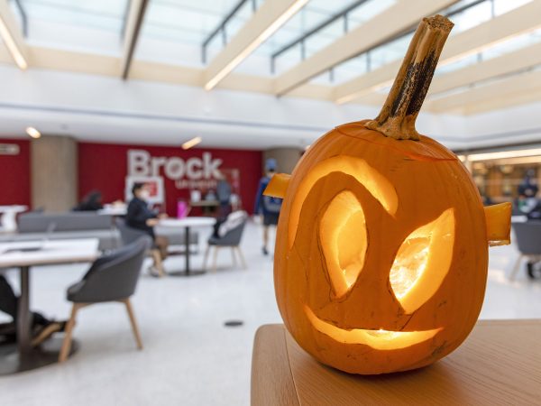 A jack-o-lantern in a sunny atrium.