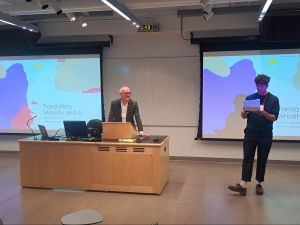 Nicholas Hauck and Michael Cronin stand at the front of a lecture hall at Brock University addressing a room.