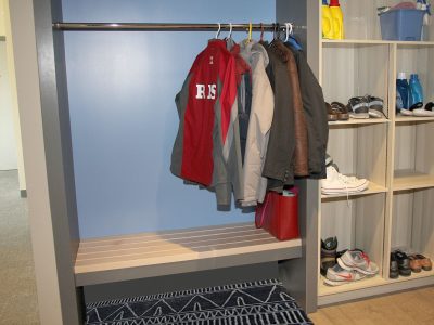 Entry way to apartment with open concept closet and wall unit for storage