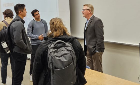 three students talking to a practicing lawyer