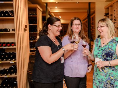 3 women enjoying a glass of wine