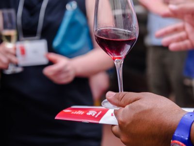 hand holding a glass of red wine