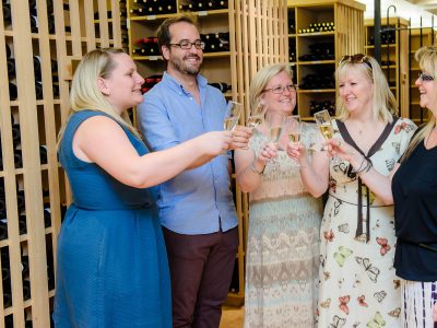 5 people enjoying a glass of wine with a cheers