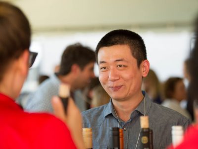 a man enjoying a wine event in conversation with others