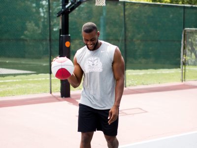 student with basketball on the courts at Walker Sports Complex