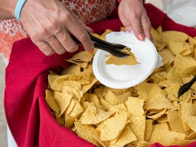 hand with tongs gathering chips