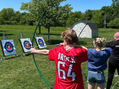 row of people doing archery