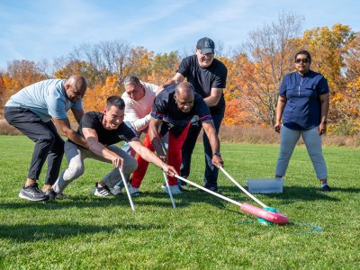 Group of adults working together in team building activity