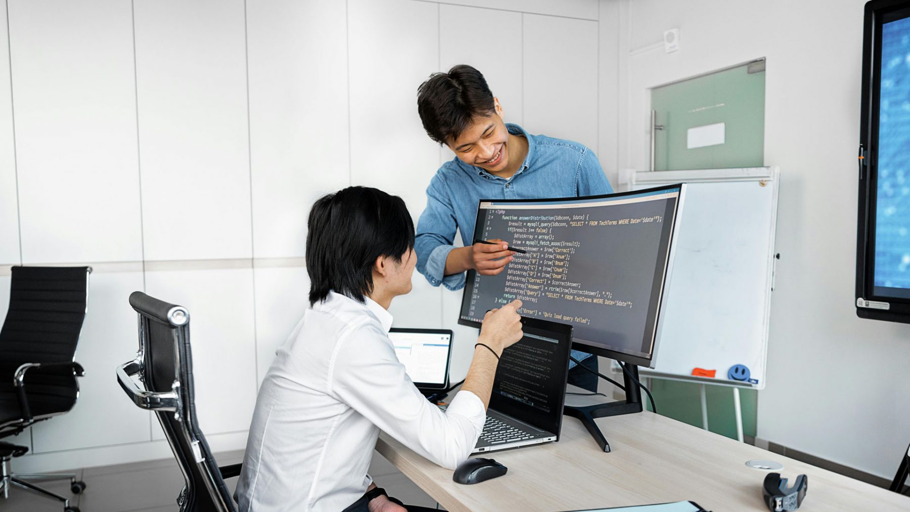 professionals looking at code on computer