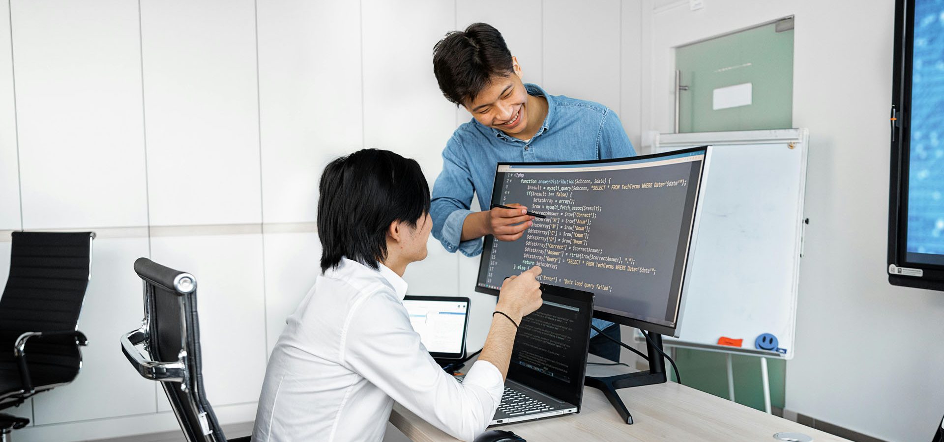 AI Powered Web Development Foundations professionals looking at code on computer