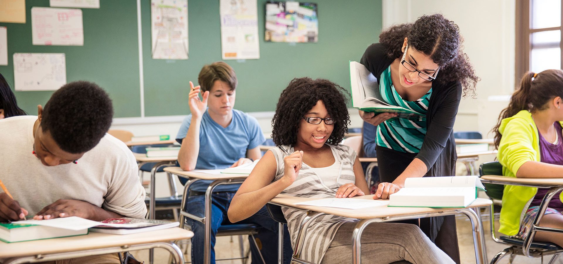 Teacher helping student in classroom