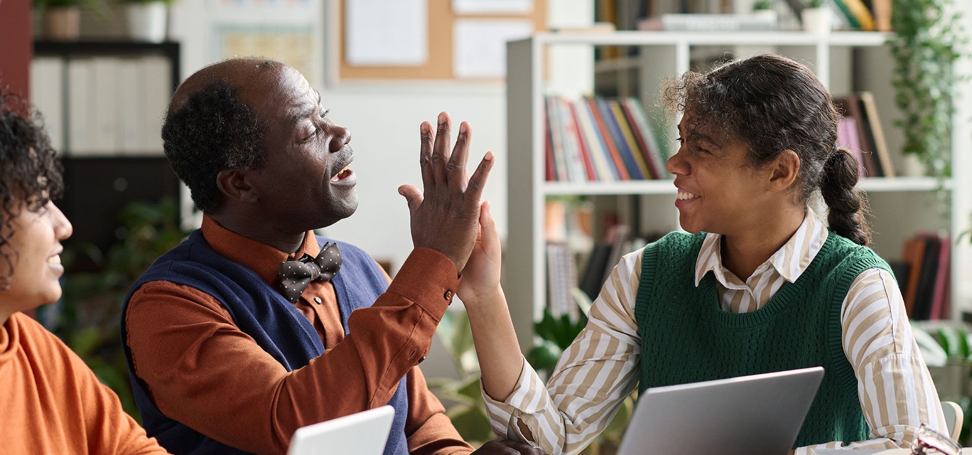 Student high-fiving with their teacher