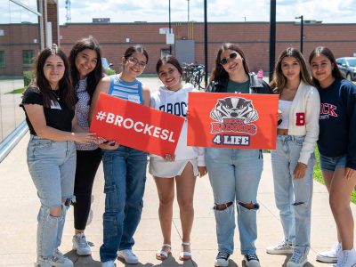 Group of student holding Brock signs