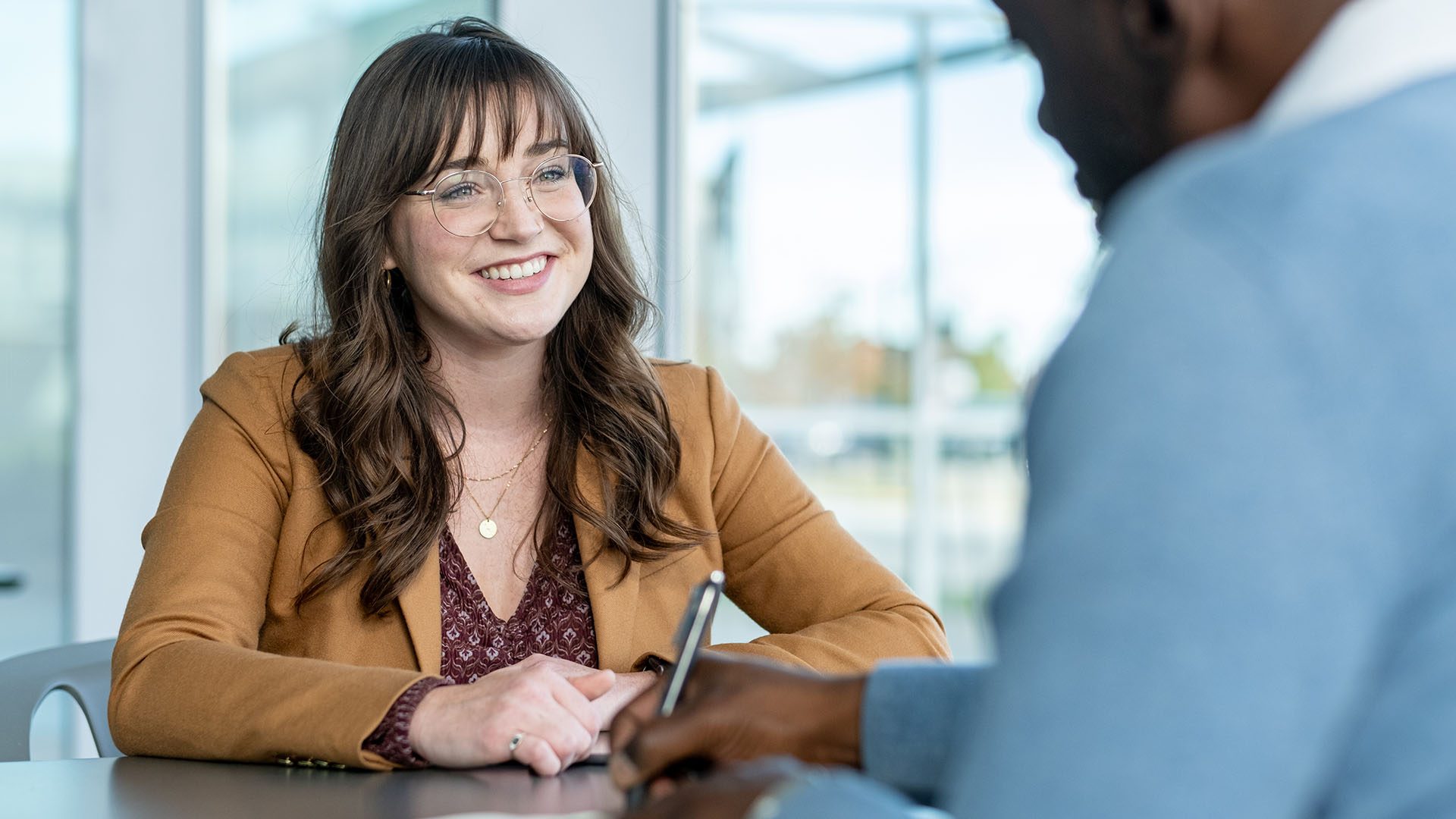 woman sitting in atrium smiling