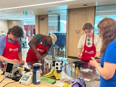 students in Brock aprons learning crafts