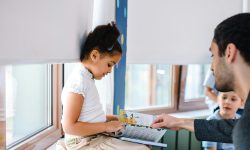 Teacher flipping a page with a student