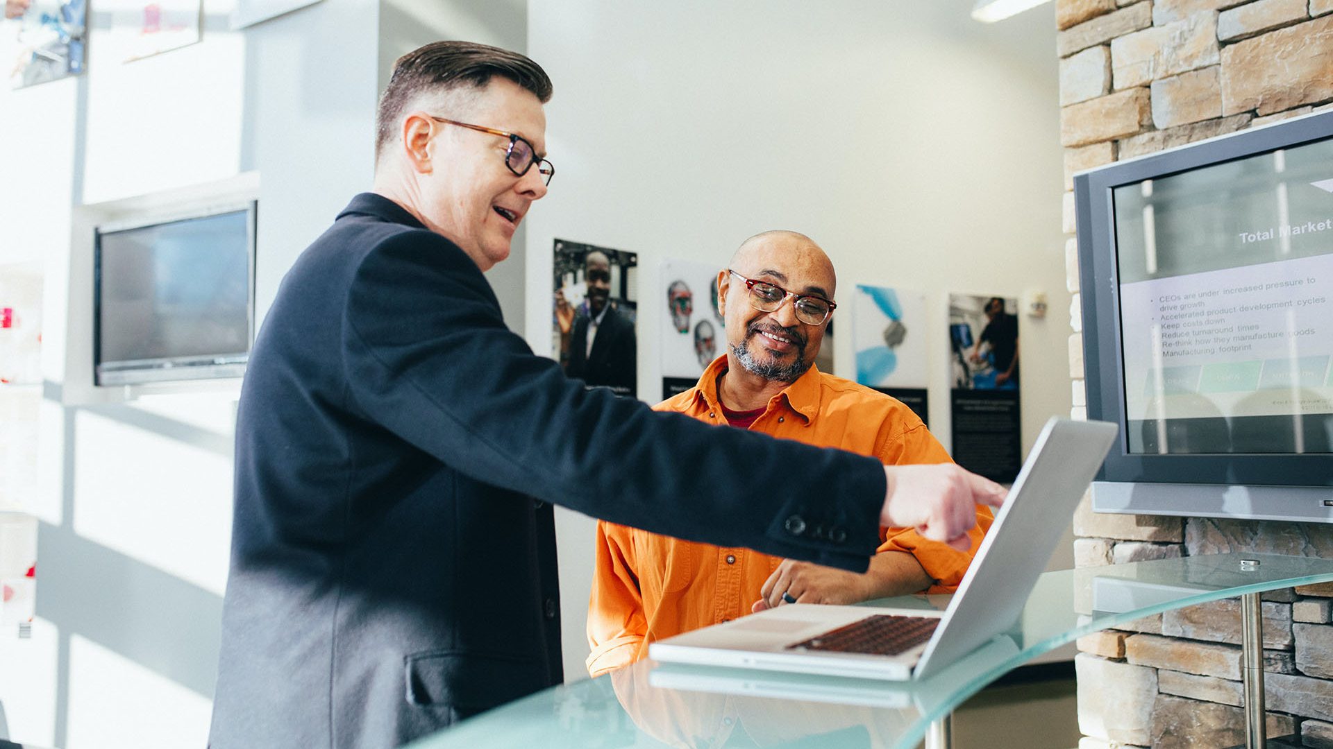 two men in retail store with laptop