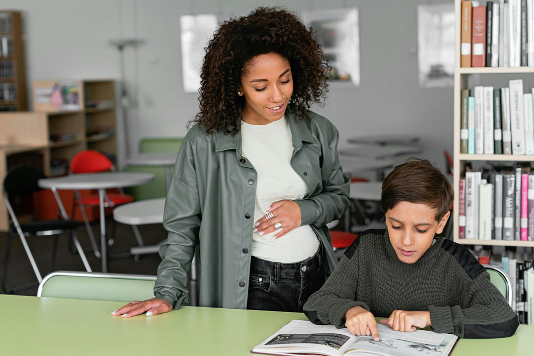 Teacher and student reading book
