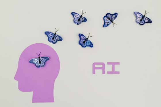 Graphic showing silhouette of head with butterflies and text that reads "AI"