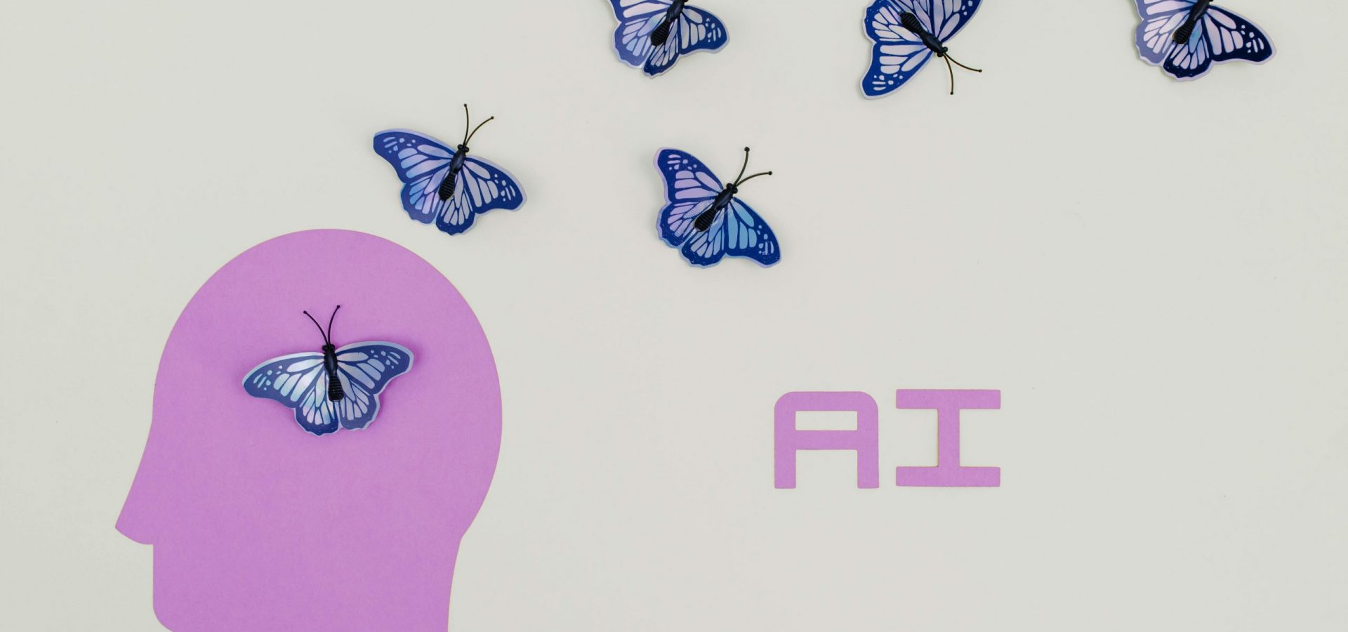 pexels-tara-winstead-8849282 Graphic showing silhouette of head with butterflies and text that reads "AI"