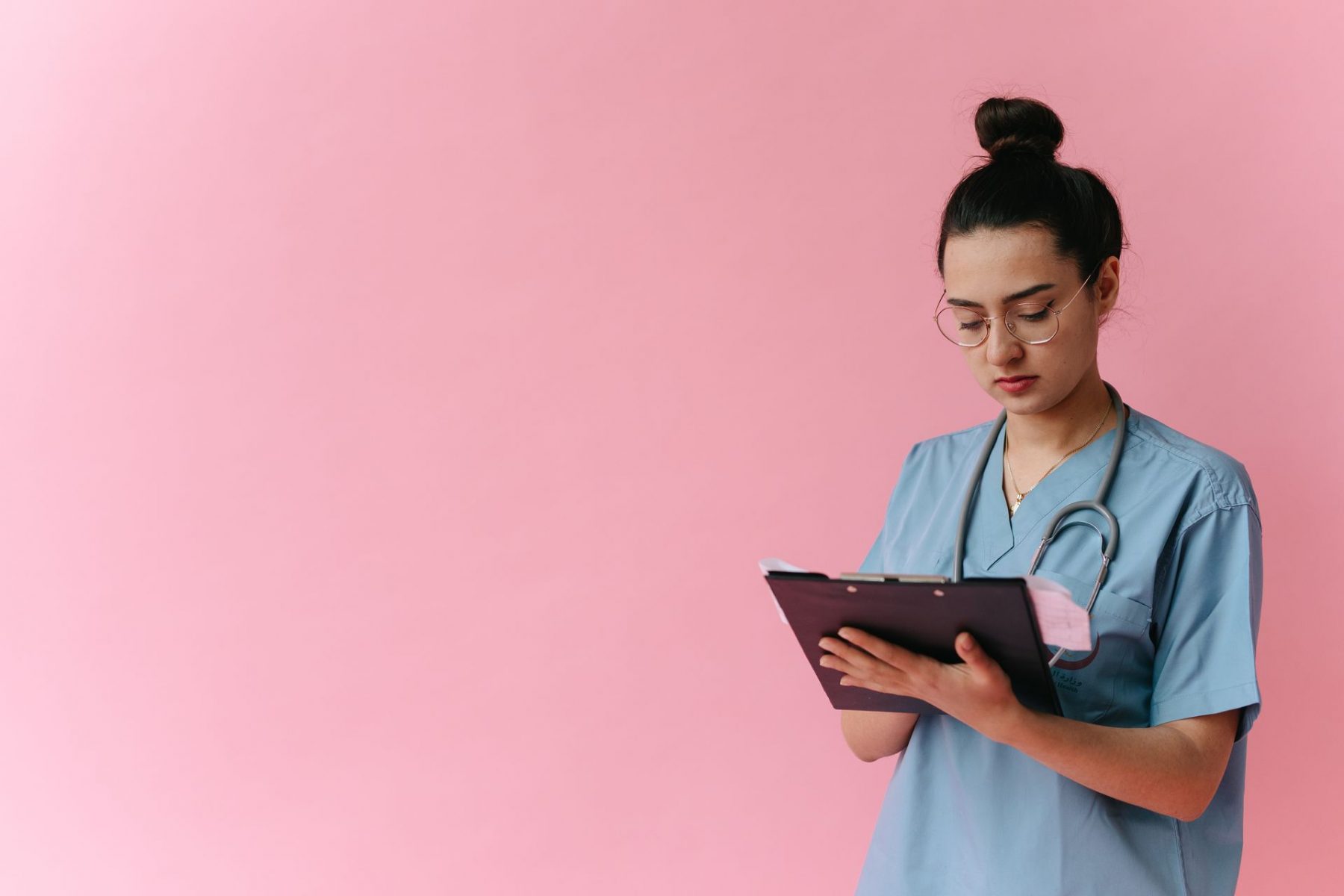 Nurse looking at clipboard