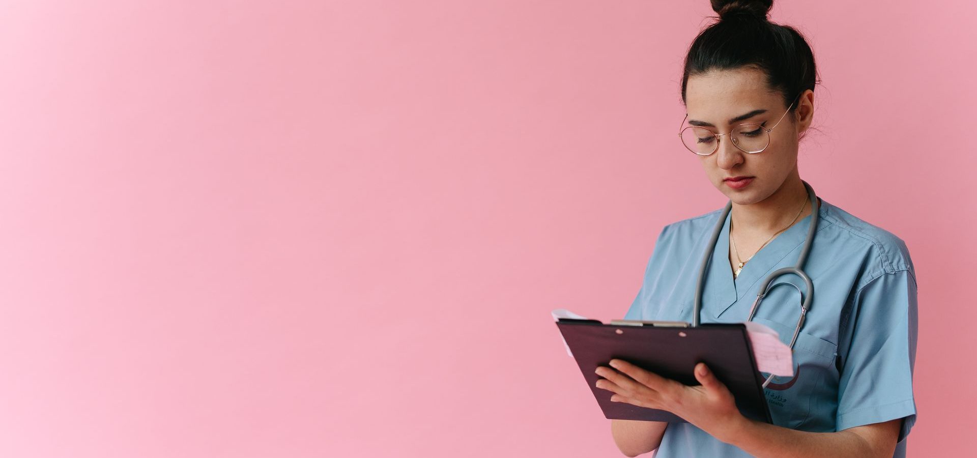 Nurse looking at clipboard